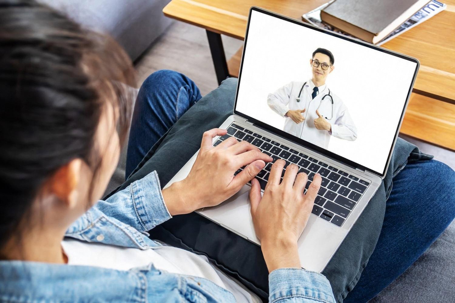 Doctor studying on a laptop during an online medical exam preparation session